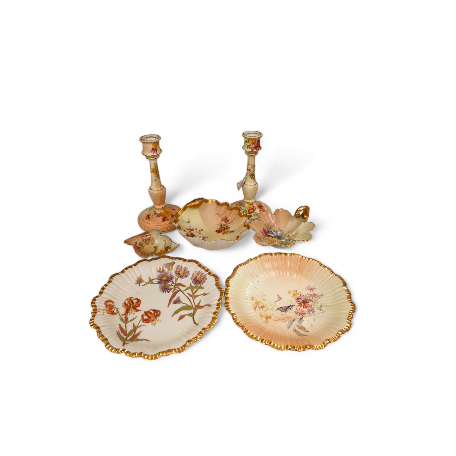 A pair of Royal Worcester blush ivory candlesticks, three bon bon dishes and a pair of plates, tallest 20cm. Condition - mostly good, some damage